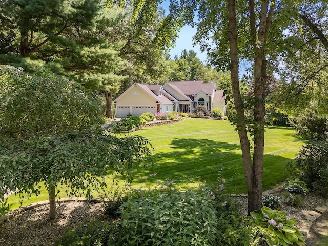 exterior space featuring a garage and a front lawn