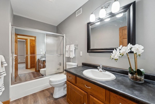 S2916A Fairway Dr, Reedsburg, WI 53959 - full bathroom with hardwood / wood-style flooring, combined bath / shower with glass door, vanity, and toilet