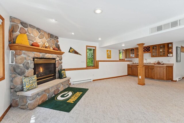 S2916A Fairway Dr, Reedsburg, WI 53959 - living room featuring a fireplace, indoor wet bar, baseboard heating, and light colored carpet