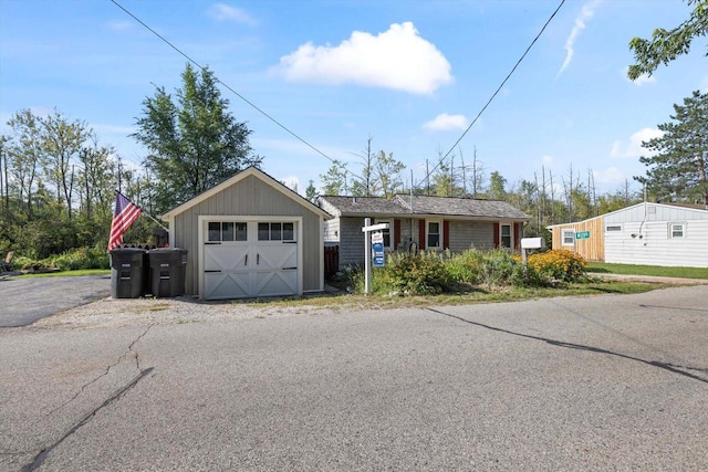 view of front of property with an outdoor structure and a garage