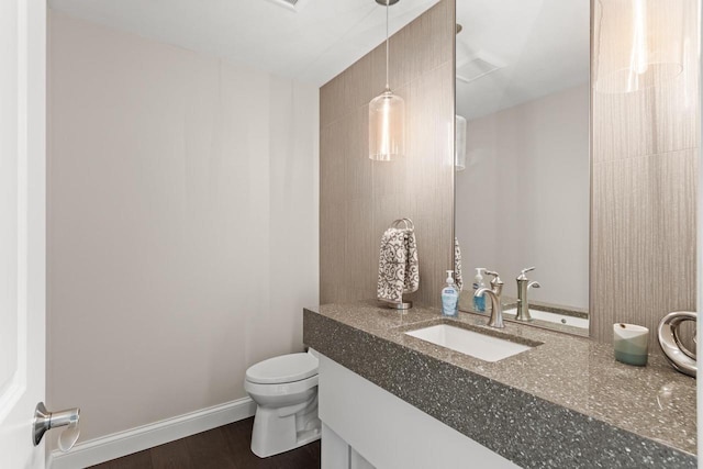 bathroom featuring hardwood / wood-style floors, vanity, and toilet