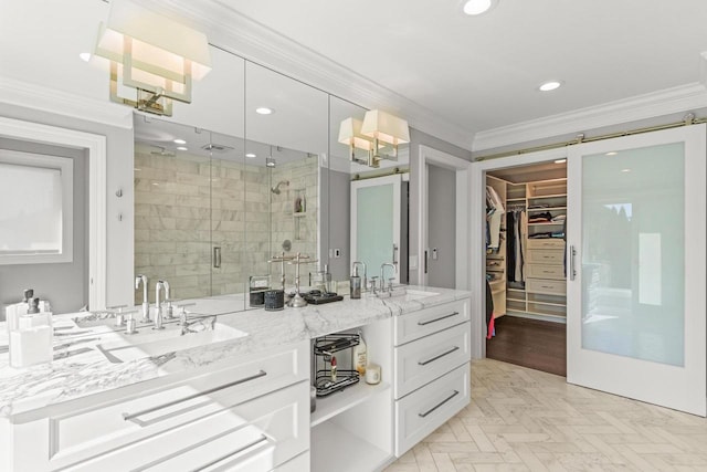 bathroom with ornamental molding, vanity, and an enclosed shower