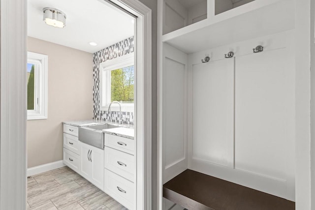 mudroom featuring light hardwood / wood-style flooring and sink