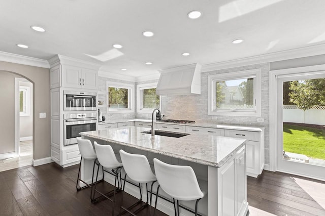 kitchen with white cabinets, a center island, dark wood-type flooring, and sink