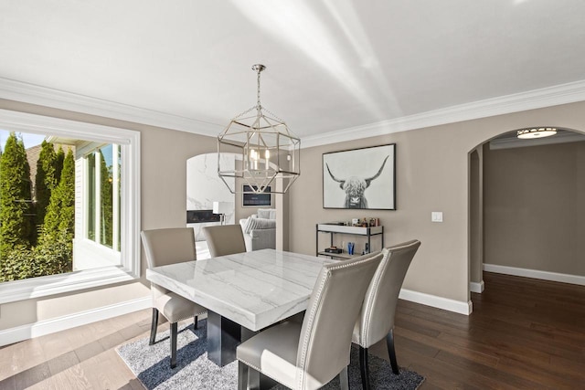 dining room with an inviting chandelier, crown molding, and hardwood / wood-style floors