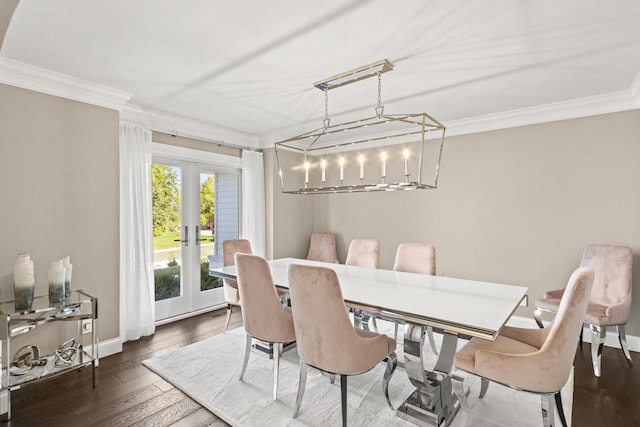 dining room with dark hardwood / wood-style floors, french doors, and crown molding