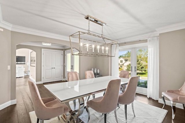 dining space with ornamental molding, french doors, and dark hardwood / wood-style flooring