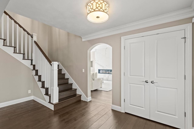 stairway featuring hardwood / wood-style floors and crown molding