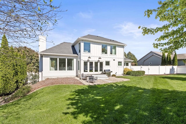 rear view of property with a yard and a patio