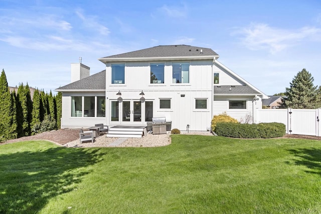 rear view of house featuring a yard and a patio