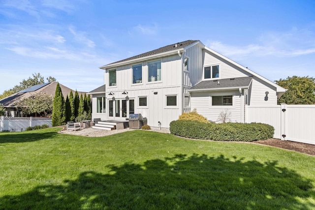 rear view of house with a yard and a patio area