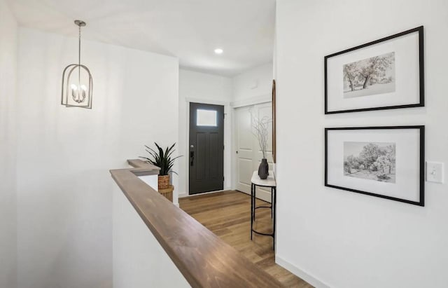 entrance foyer featuring light wood-type flooring and an inviting chandelier