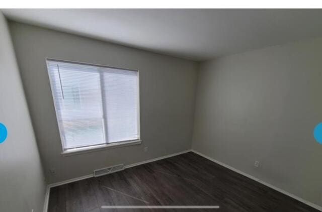 spare room with hardwood / wood-style flooring