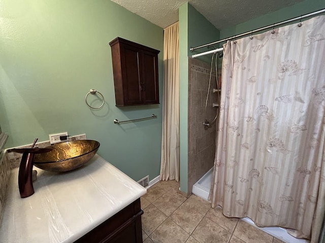 bathroom featuring tile patterned floors, a textured ceiling, and vanity