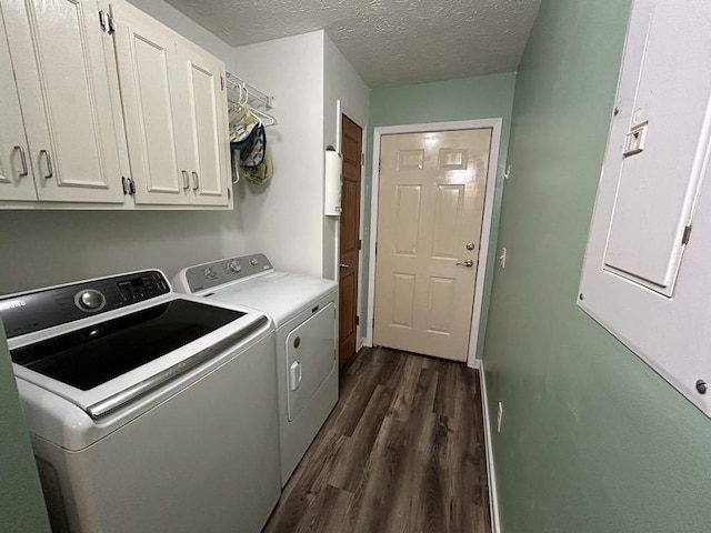 washroom with a textured ceiling, dark hardwood / wood-style floors, independent washer and dryer, and cabinets