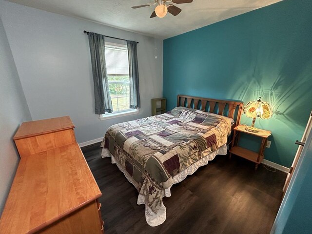 bedroom with ceiling fan and dark wood-type flooring