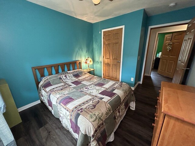 bedroom with ceiling fan and dark wood-type flooring