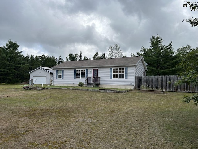 view of front of property featuring a garage and a front yard