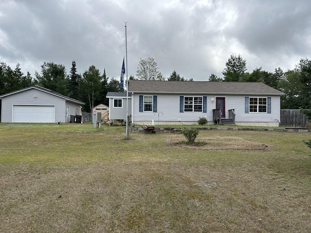 view of front of house featuring an outbuilding, a garage, and a front lawn