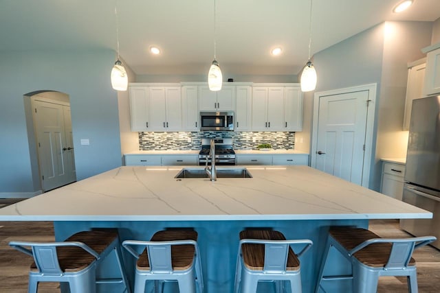 kitchen with pendant lighting, stainless steel appliances, and a large island