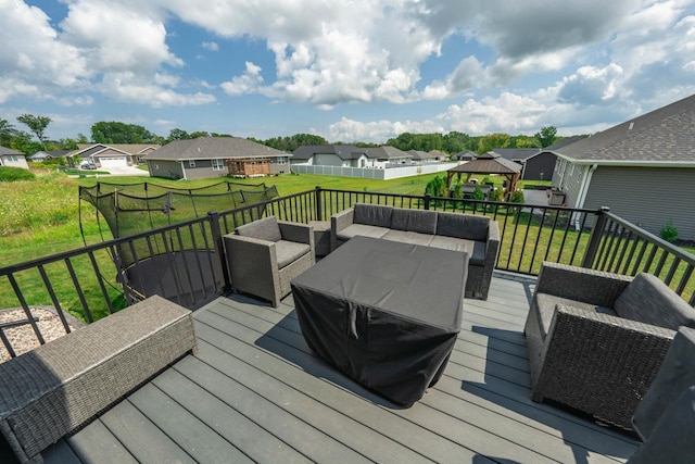 wooden terrace with a lawn, an outdoor living space, and a gazebo