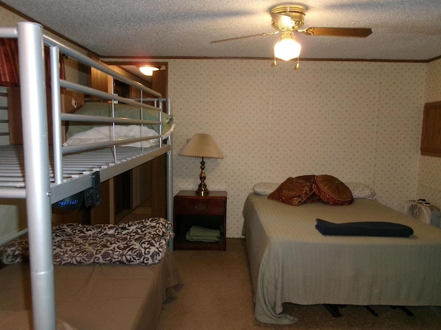 N3567 Manning Dr Unit 45, Montello, WI 53949 - carpeted bedroom with a textured ceiling, wallpapered walls, and a ceiling fan
