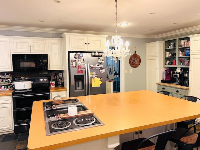 kitchen with hanging light fixtures, black appliances, an inviting chandelier, ornamental molding, and a kitchen breakfast bar