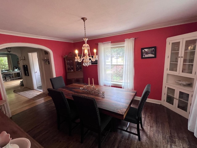 dining area featuring a chandelier, dark hardwood / wood-style floors, and ornamental molding