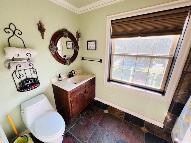 bathroom featuring toilet, crown molding, and vanity