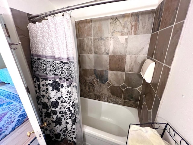 bathroom with shower / bath combination with curtain