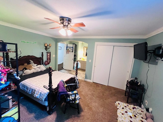 bedroom featuring a closet, ceiling fan, carpet floors, and ornamental molding