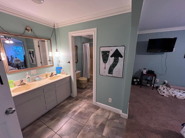 bathroom with tile patterned floors, ornamental molding, vanity, and toilet