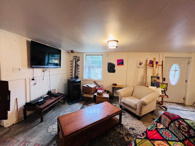 living room with a wood stove and wood-type flooring