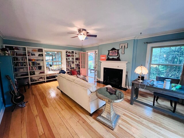 living room with hardwood / wood-style flooring, plenty of natural light, and ornamental molding