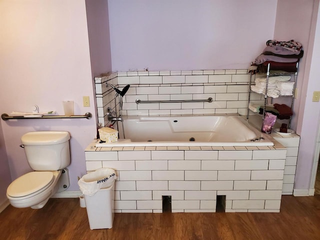 bathroom featuring a tub, wood-type flooring, and toilet