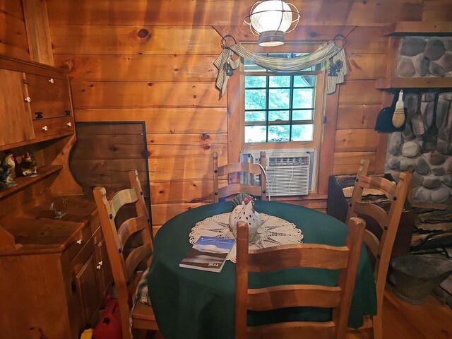 dining room with cooling unit and wooden walls