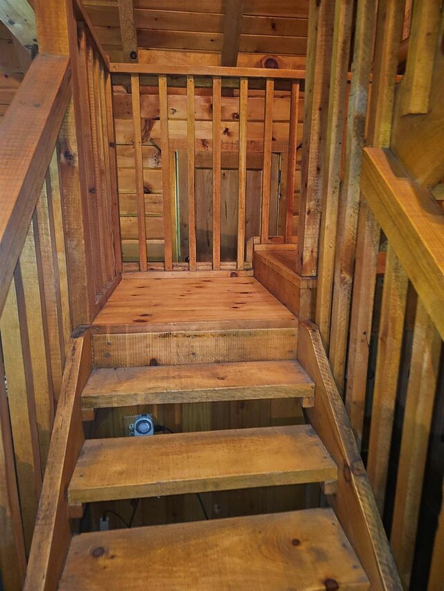 bedroom featuring hardwood / wood-style flooring and beamed ceiling