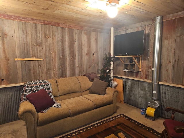 living room featuring concrete floors, wood walls, and wooden ceiling