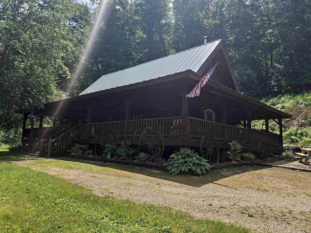 exterior space featuring a deck and a lawn