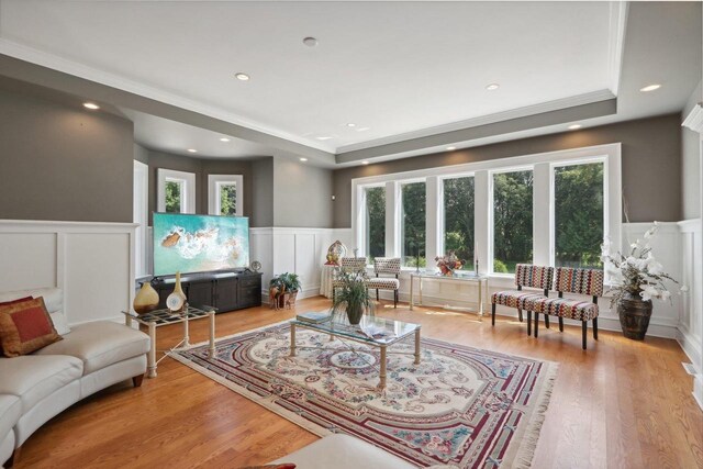 dining room with light hardwood / wood-style flooring and crown molding