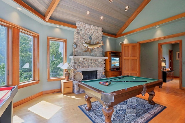 recreation room with billiards, wooden ceiling, a stone fireplace, and a healthy amount of sunlight