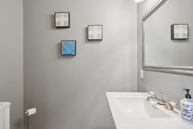 bathroom with sink, toilet, and radiator heating unit