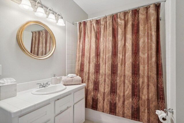 bathroom featuring separate shower and tub and vanity