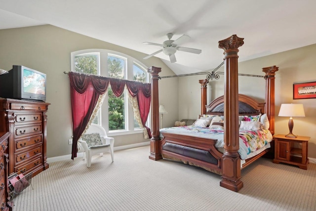 bedroom featuring multiple windows, lofted ceiling, light colored carpet, and ceiling fan