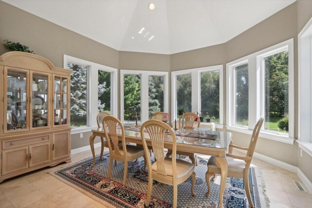 living room with light hardwood / wood-style flooring, a tray ceiling, a healthy amount of sunlight, and ornate columns