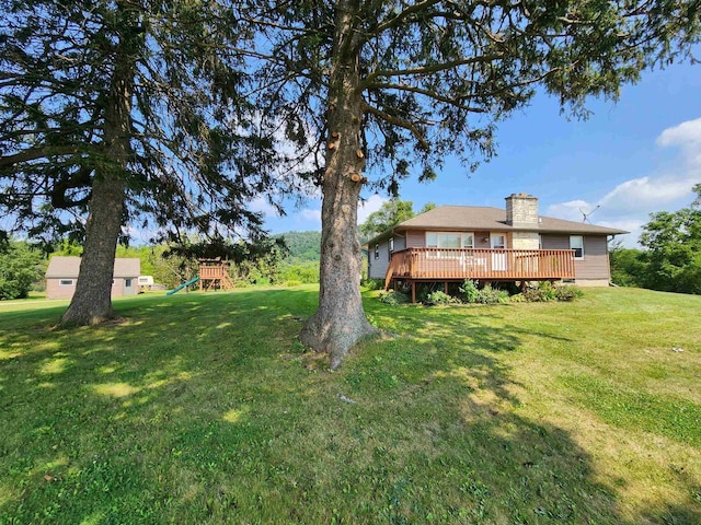 view of yard with a deck and a playground