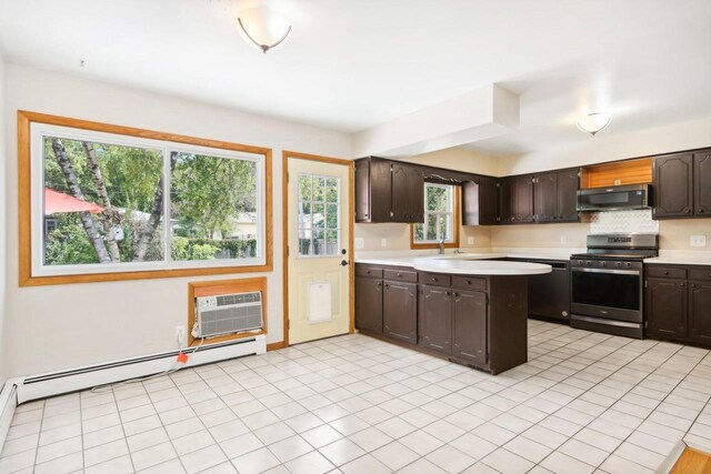 kitchen with dark brown cabinetry, a baseboard radiator, appliances with stainless steel finishes, and plenty of natural light