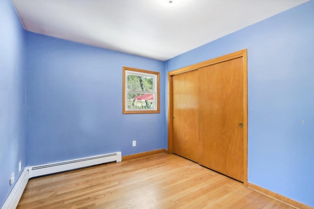 unfurnished bedroom with light hardwood / wood-style flooring and a closet