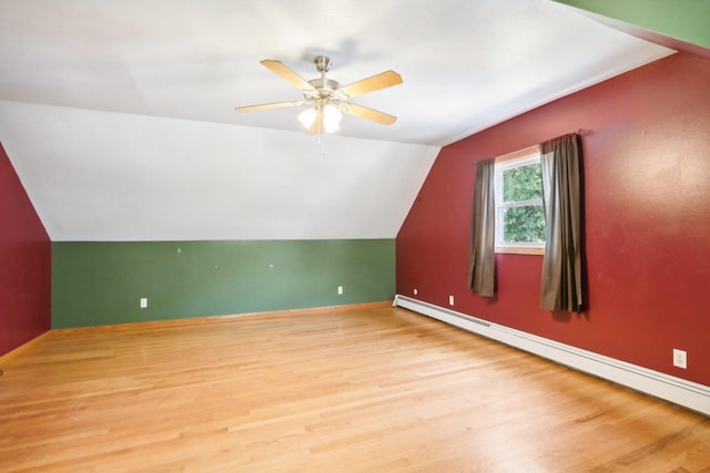 bonus room featuring light wood-type flooring, lofted ceiling, ceiling fan, and a baseboard radiator