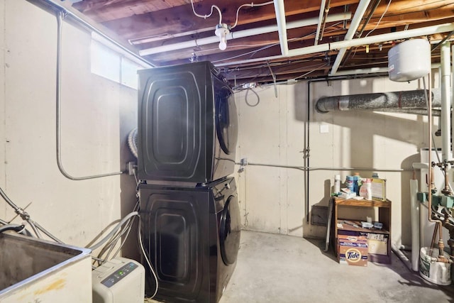 basement with stacked washer / drying machine